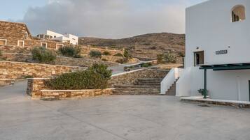 A white building with a sign reading 'BEACH' and a stone staircase leading to it.
