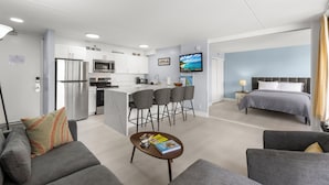 A modern apartment with a kitchen, dining area, and a bedroom. - Waikiki Banyan 1BR (Honolulu)