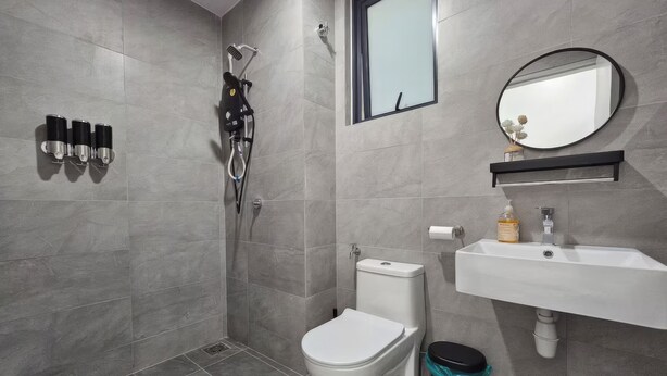 A modern bathroom with a shower, toilet, sink, and mirror. - Trefoil @ Setia City Condotel (Shah Alam)