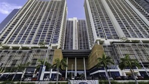 A modern high-rise building with multiple floors and large windows. - Trefoil @ Setia City Condotel (Shah Alam)