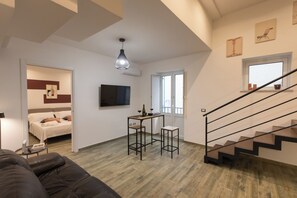 Luxury Duplex, Balcony | Living area | 50-inch Smart TV with digital channels