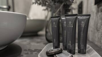 A bathroom counter with four tubes of AQUA BLANCA conditioner and a broken soap bar.