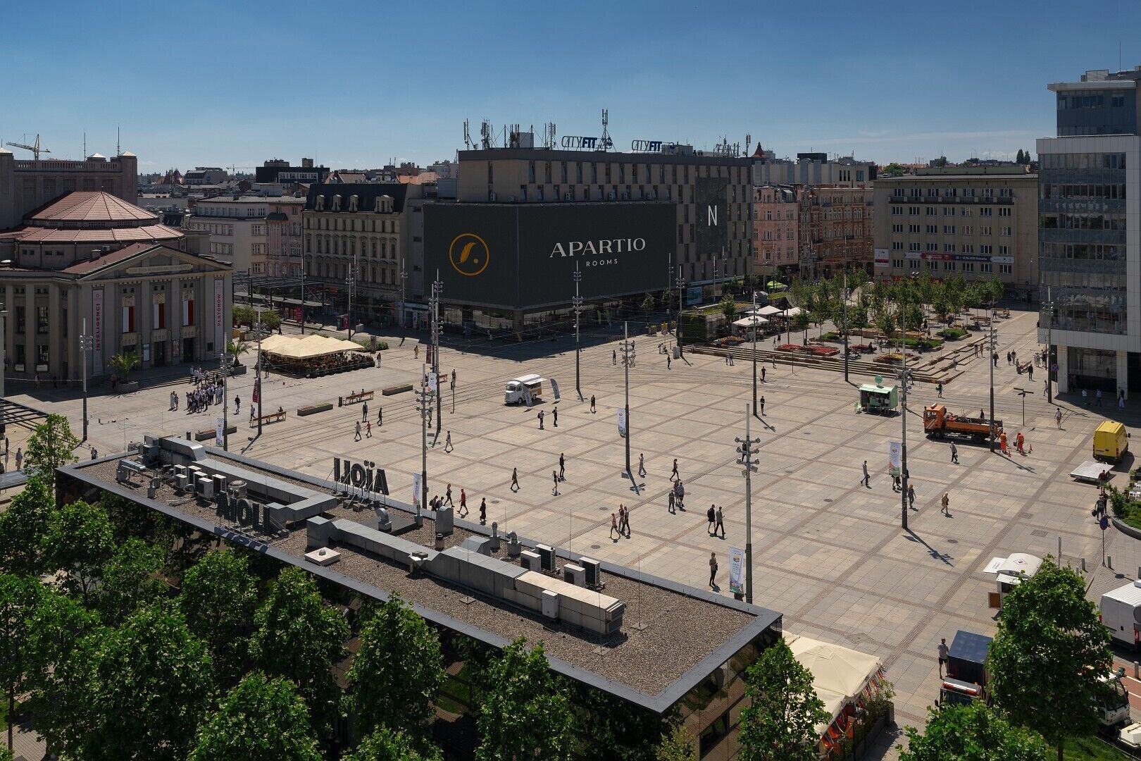 A spacious public square with a large building labeled "APARTIO ROOMS" in the center.