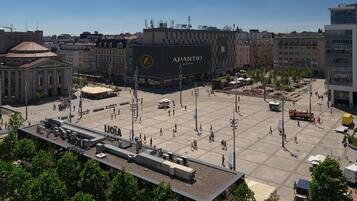 A spacious public square with a large building labeled "APARTIO ROOMS" in the center.