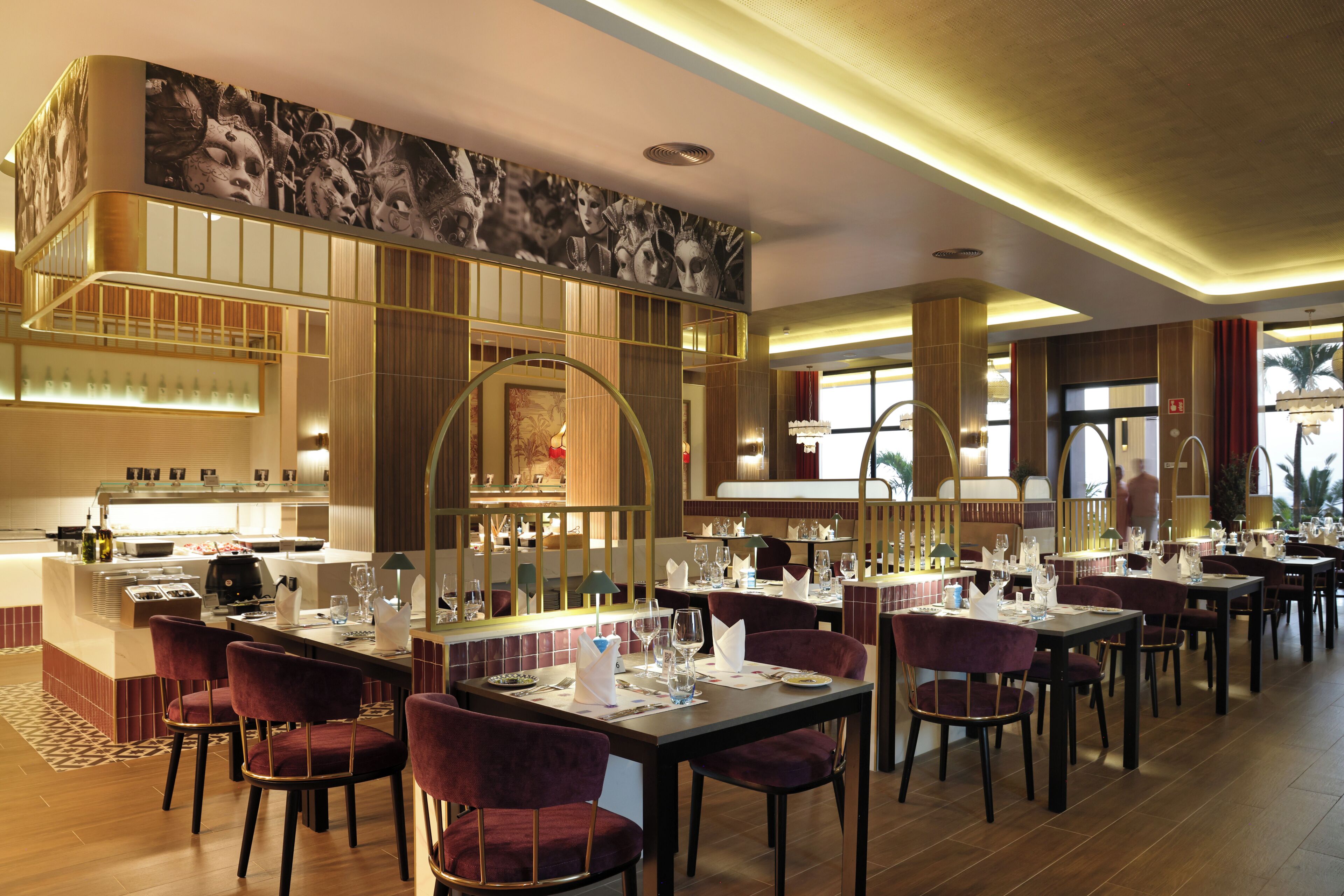 A restaurant with multiple dining tables, chairs, and a bar area.