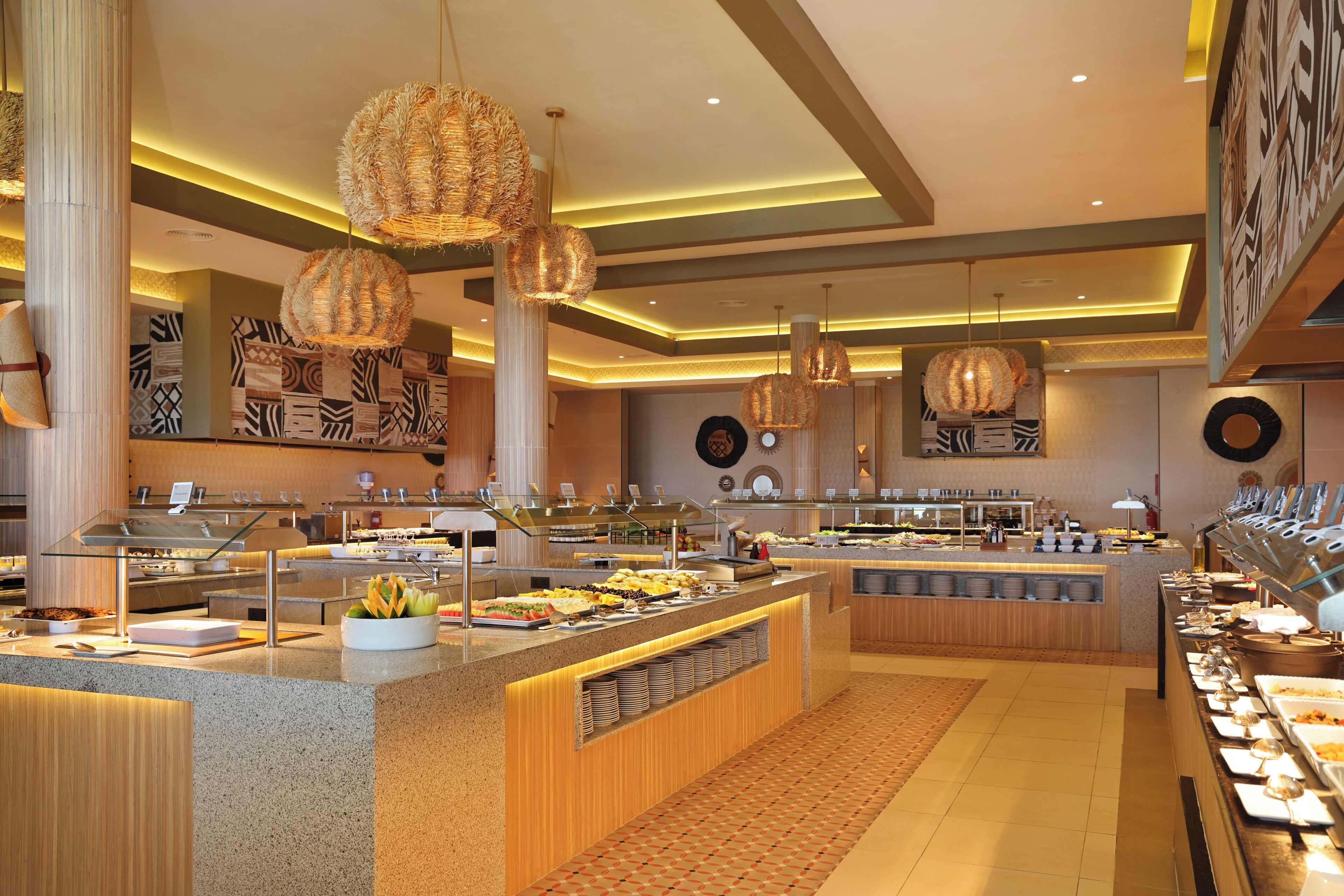 A buffet with various food stations, a central serving area, and decorative lighting.