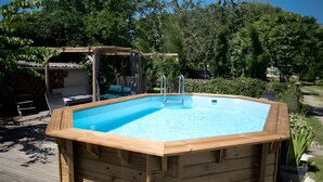 A wooden hot tub with a ladder, surrounded by a deck and a pergola. - Le Fil Rouge – A Warm Holiday Home Blending Stone and Design in the Countryside (Saint-Pierre-d'Aurillac)