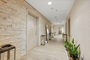 A hallway with a brick wall, wooden floor, and a row of lanterns. - Brickell Floor 31 Sea View-Free Parking by Palermo Home (Miami)