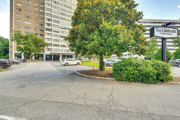 Ein Parkplatz, im Hintergrund ein Gebäude mit der Aufschrift 'The Landmark Condominiums'.