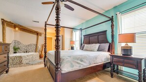 A four-poster bed with a wooden frame and a ceiling fan, a nightstand with a lamp, and a stone-patterned dresser. - 17 Mi to Disney: Getaway in Davenport w/ Game Room (Davenport)