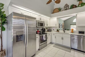 A modern kitchen with stainless steel appliances, white cabinetry, and a built-in oven. - Disney Getaway w/ Private Hot Tub 14 Mi to Parks (Kissimmee)