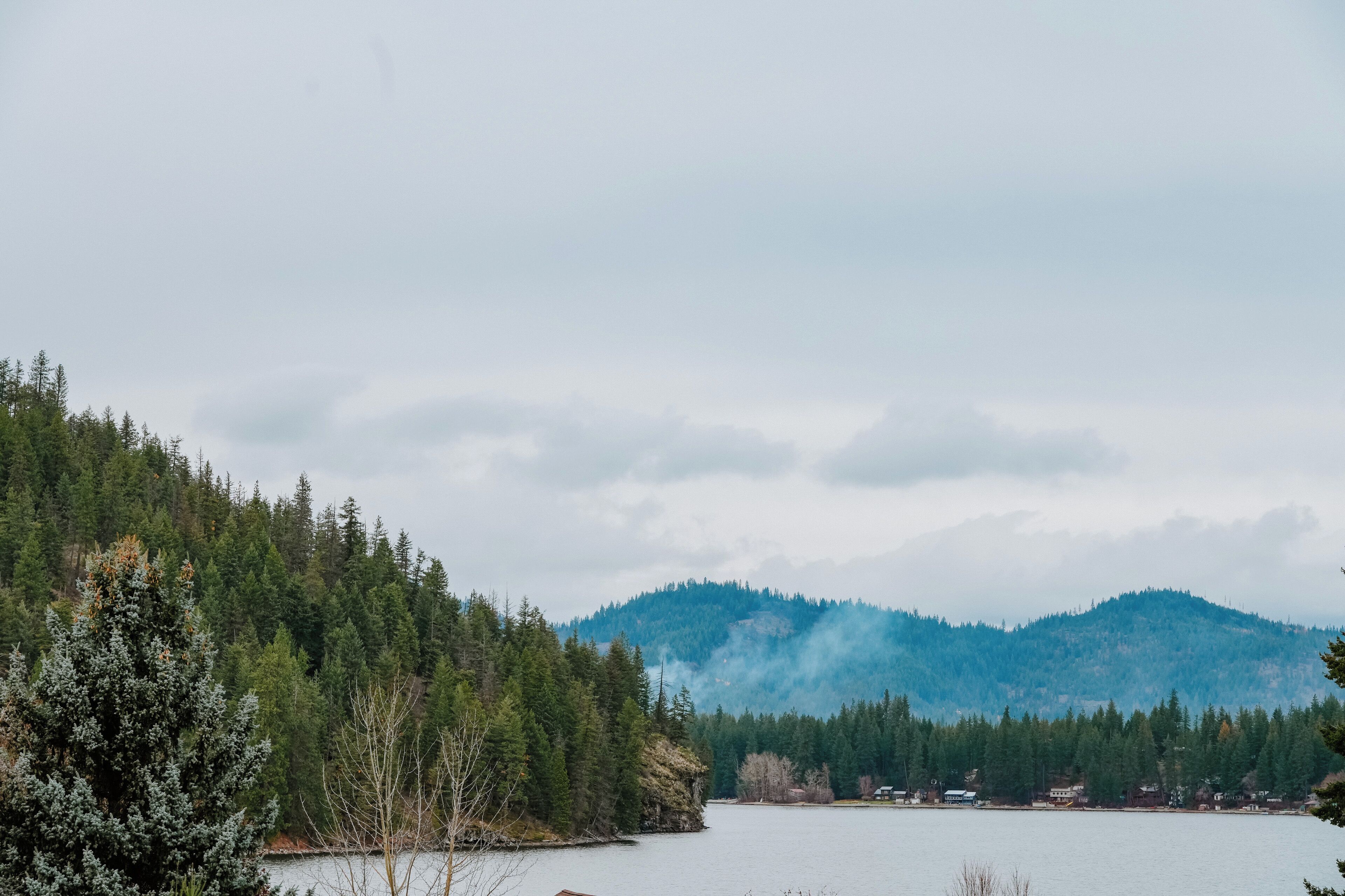 A lake surrounded by dense forests and mountains.