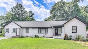 A single-story house with a front porch, a small front yard, and a garage. - 1 Mi to Dtwn Monroe: Family-friendly Duplex! (Monroe)