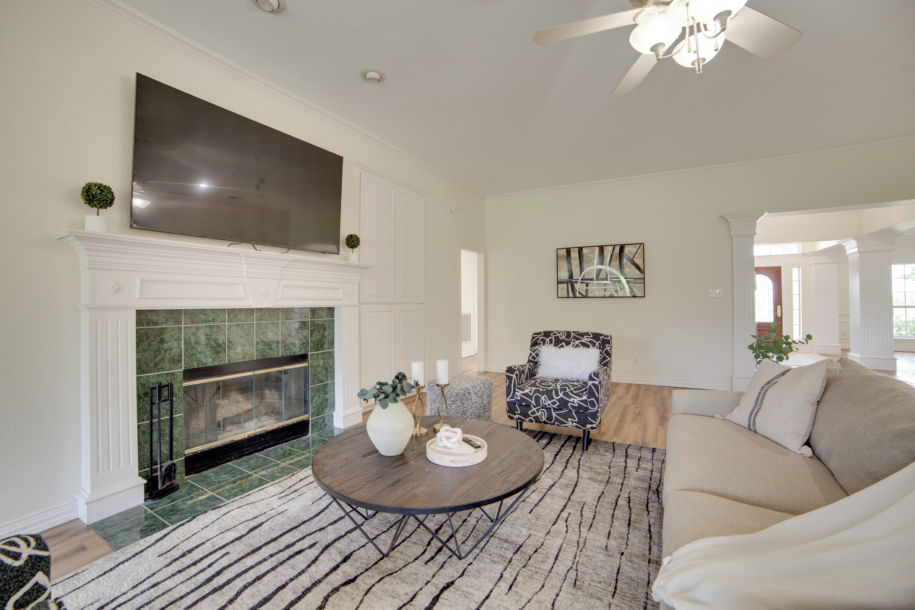 A living room with a fireplace, a sofa, a coffee table, and a chair.