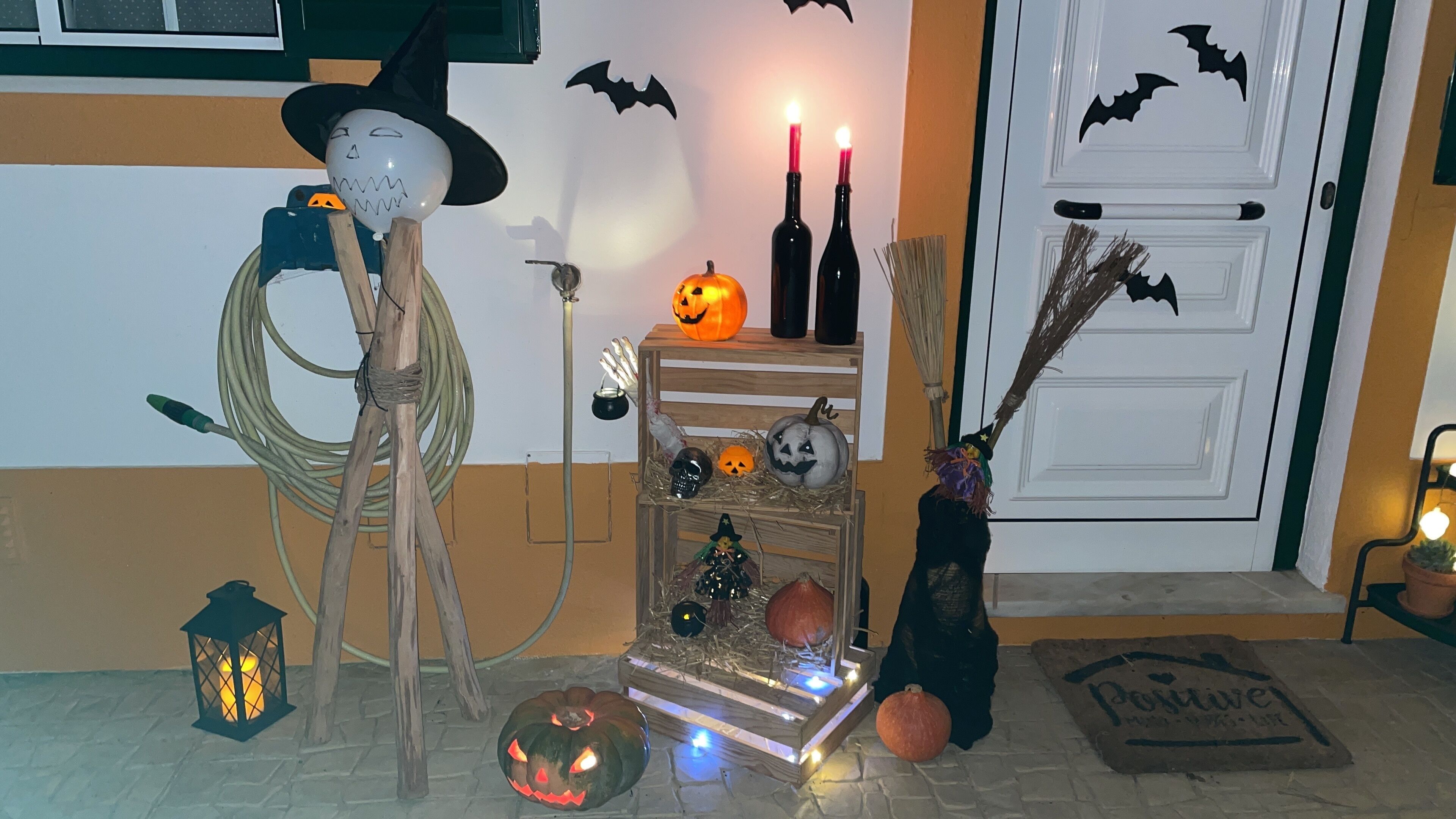 A Halloween-themed display with pumpkins, candles, and witch decorations.