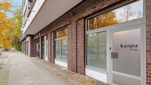 A building with a brick facade, large windows, and a sign reading 'kaspa living'.