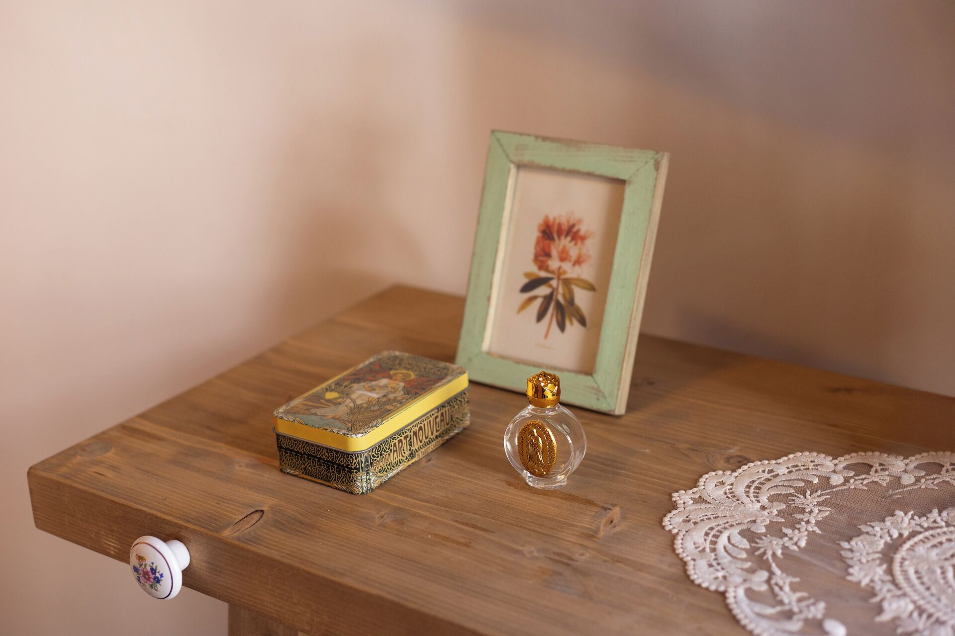 A wooden table with a small box, a decorative item, and a framed picture.