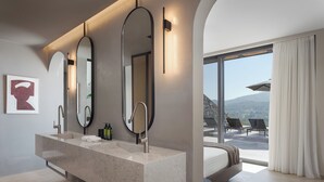 A modern bathroom with a large vanity, three mirrors, and a view of the outdoors. - Neromai Cave Luxury Villa One (Rethymno)