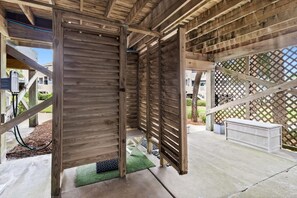 A wooden structure with a slatted roof, concrete flooring, and a lattice fence in the background. - Dog-Friendly 3BR · Gulf Beach Steps Away· Sleeps 9 (Port St. Joe)
