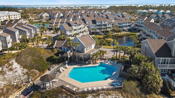 A coastal residential area with a large swimming pool surrounded by houses.
