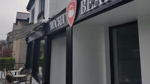 A building with a sign for "MOCHA BEANS" and a red logo. - 1997 Stays Galway (Galway)