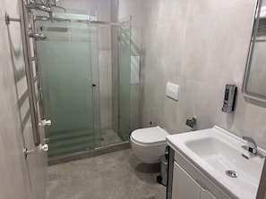 Bathtub, hair dryer, slippers, towels