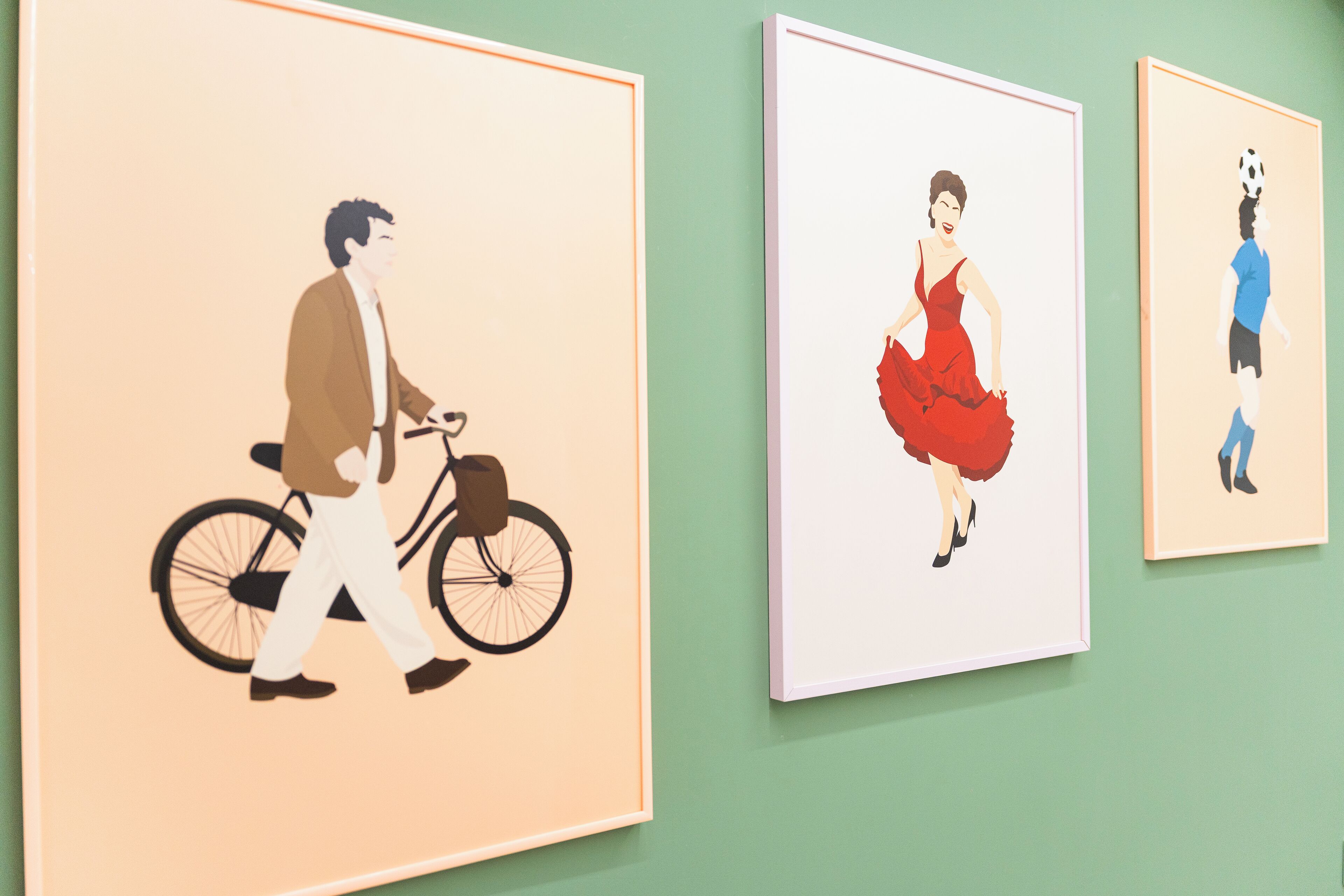 Drei gerahmte Kunstwerke an einer Wand.