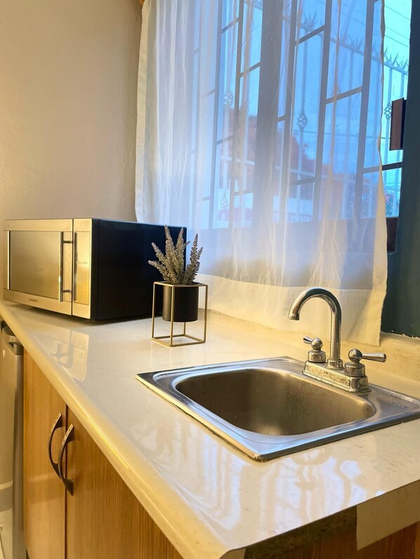 Desk, laptop workspace, blackout drapes, iron/ironing board