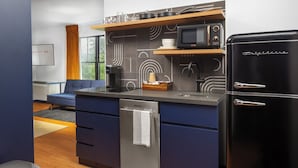 A modern kitchen with a built-in microwave, a Frigidaire refrigerator, and a dishwasher.