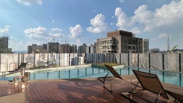 Outdoor pool, open 7:00 AM to 10:00 PM, pool umbrellas, pool loungers