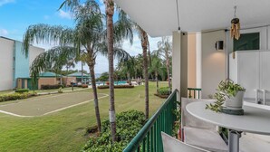 A view of a pool area with palm trees, a tennis court, and a covered seating area. - Tropical Escape With Pool Tennis Cabo Rojo (Cabo Rojo)