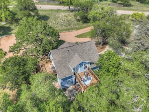 A house with a deck and a fenced yard.