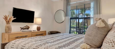 Sink into plush bedding and wake to gentle natural light filtering through your window, with a peaceful view of palm trees and greenery welcoming you to each Florida morning.