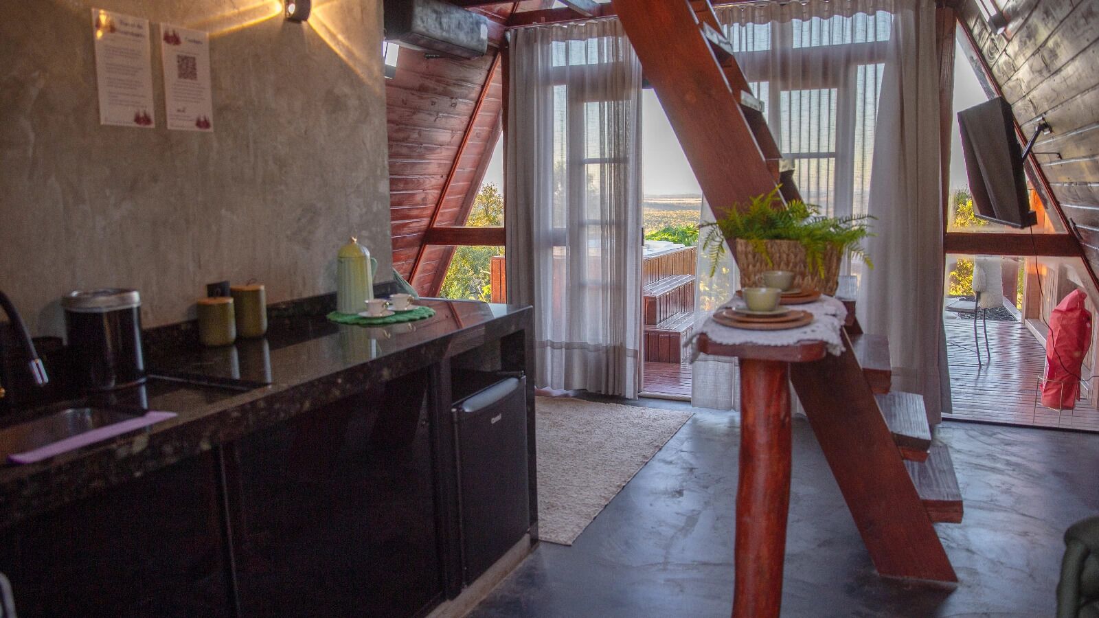 Una cocina moderna con una isla grande, un comedor con mesa de madera y vistas al exterior.