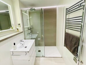 Shower, hair dryer, towels, soap