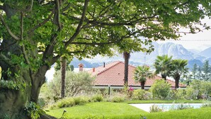 A house with a red-tiled roof, surrounded by lush greenery and a swimming pool. - Hidden Gem-Villa with private pool Bellagio view (Lierna)