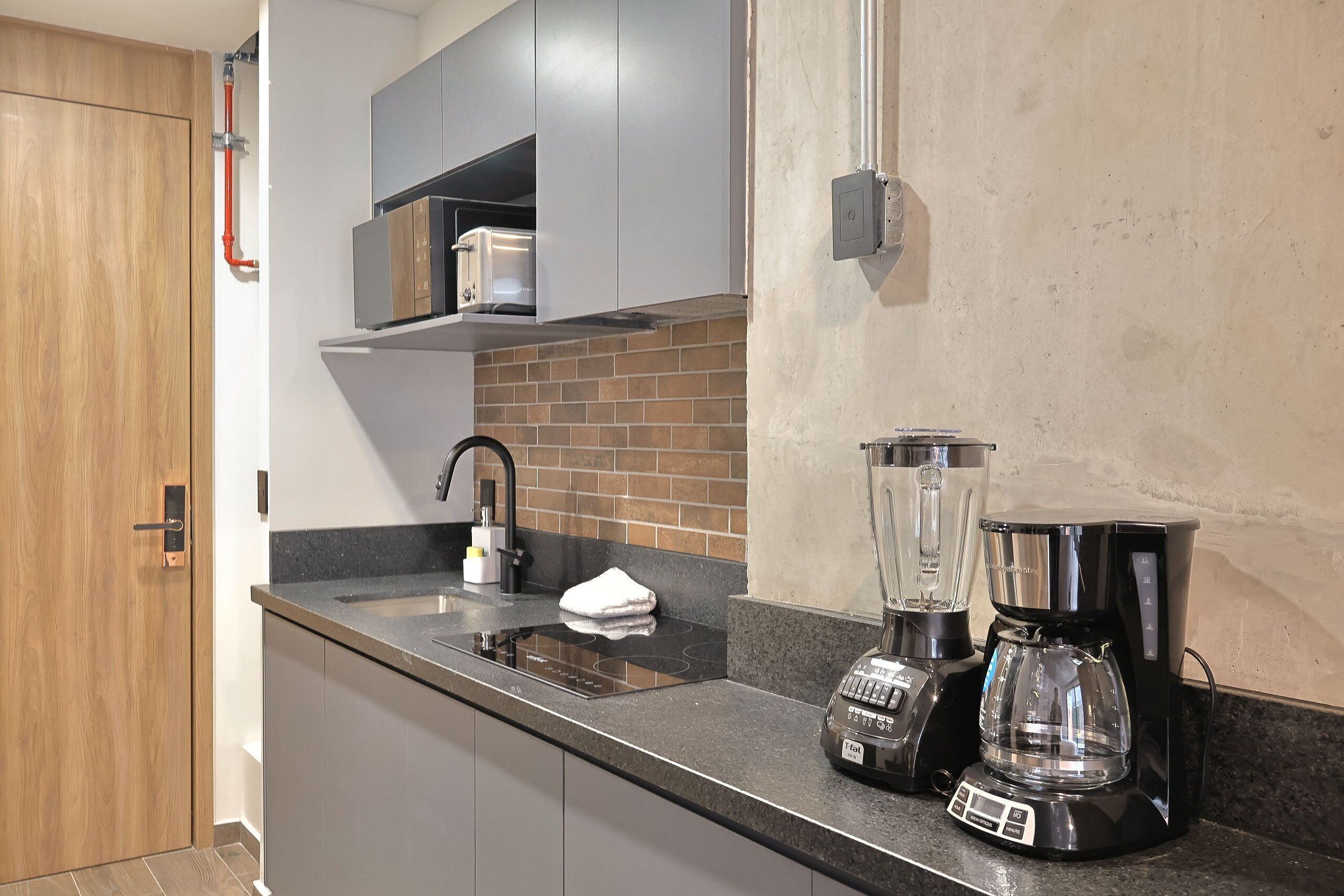 Fridge, microwave, coffee/tea maker, cookware/dishes/utensils