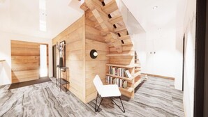 Un interno moderno con una parete in legno, una sedia bianca e una libreria.