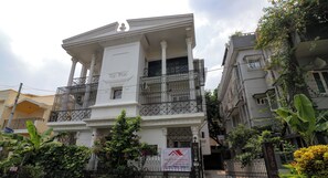 A multi-story building with a balcony, a signboard, and a gated entrance. - Sai International (Bidhannagar)