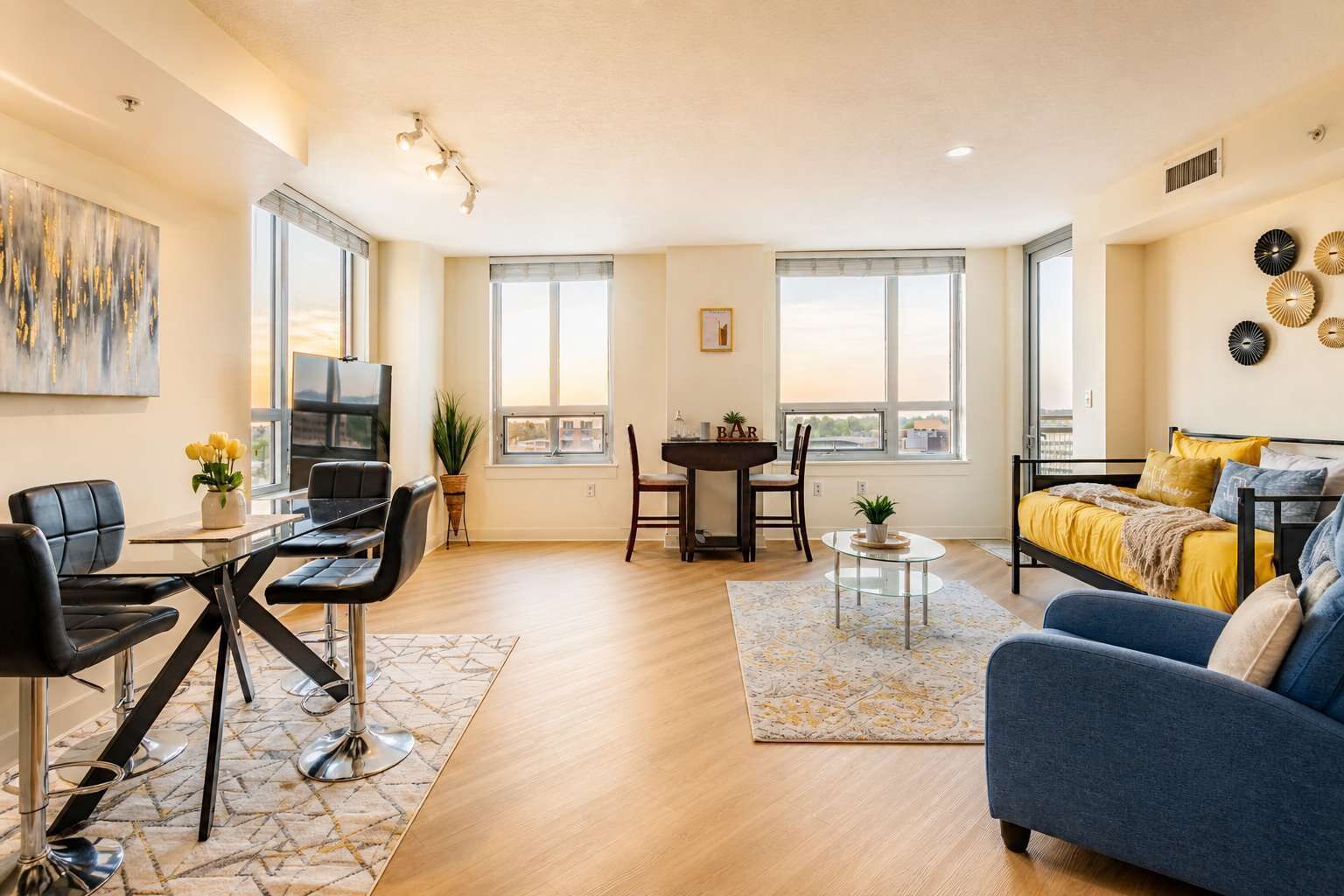 Sunlit living space with dining area and sofa bed for extra guests — book now and settle in.