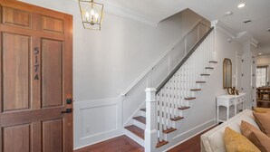 A staircase with white railings and wooden steps, a wooden door with the number 517A, and a chandelier. - Rose House - 2 Primary Suites, Easy Parking (Savannah)