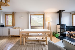 A modern interior with a wooden table, bench, and a sofa.