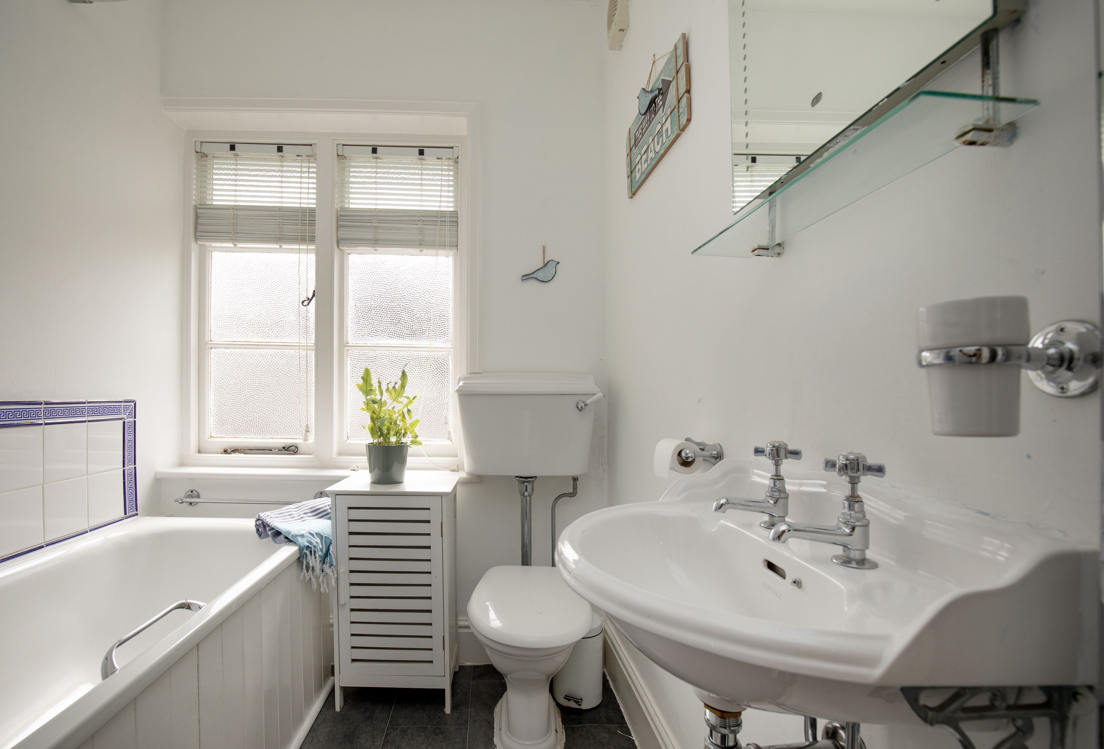 A bathroom with a bathtub, toilet, and sink.