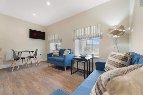 A modern living room equipped with a smart TV with Netflix and plenty of space to sit down and relax after a day of exploring.