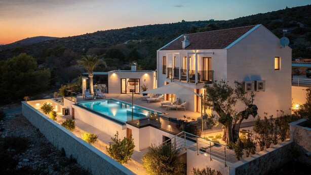 A modern villa with a swimming pool, outdoor seating, and a view of the surrounding landscape. - Villa Bacci di Sole with Pool (Rogoznica)