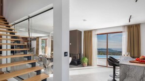 A modern interior with a staircase, a dining area, and a kitchen with a view. - Villa Bacci di Sole with Pool (Rogoznica)