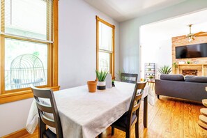 A dining area with a table, chairs, and potted plants. - Short North & Downtown & OSU | Near High Street | Free Parking | 5,800+ Reviews (Columbus)