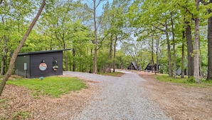 A gravel path leading to a cabin labeled 'Well House' surrounded by trees.