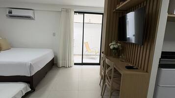 Basic Studio | Desk, blackout drapes, iron/ironing board, travel crib