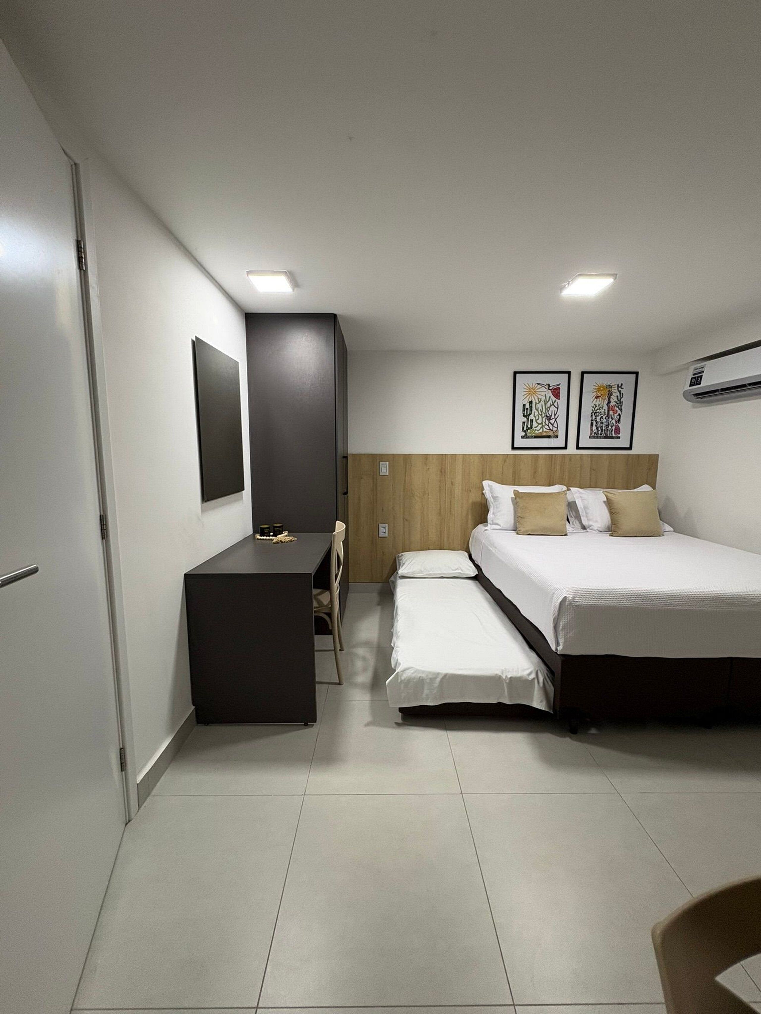 Basic Studio | Desk, blackout drapes, iron/ironing board, travel crib